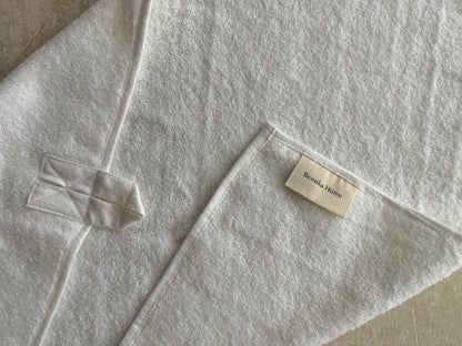 Close up of white hand towel with hanging loop and Bensika Home tag